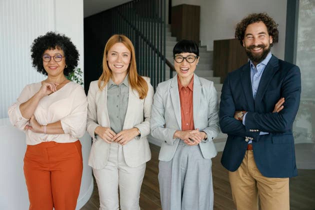 Smiling business team standing together in modern corporate office model released, Symbolfoto property released, FLMZF03046