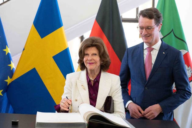 Queen SILVIA of SWEDEN, signs the golden book of the state government, Hendrik WUEST, Wüst, CDU, State Premier of North Rhine-Westphalia, welcomes Queen SILVIA of SWEDEN, in the State Chancellery in Duesseldorf on 23 03 2026