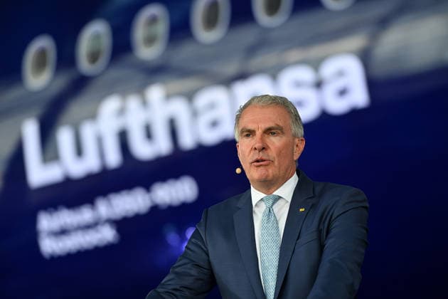 Carsten SPOHR Chairman Lufthansa holds a speech in front of the Lufthansa Jet Airbus A350 900 Rostock single image,cropped single motif,half figure,half figure anniversary 100 years Lufthansa on 23 03 2026 in the aircraft hangar Flight Operation Center at Franz Josef Strauss Airport in Munich