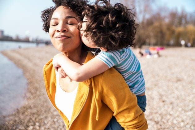 Family enjoying happy outdoor moment at river beach with a kiss model released, Symbolfoto, UUF36445