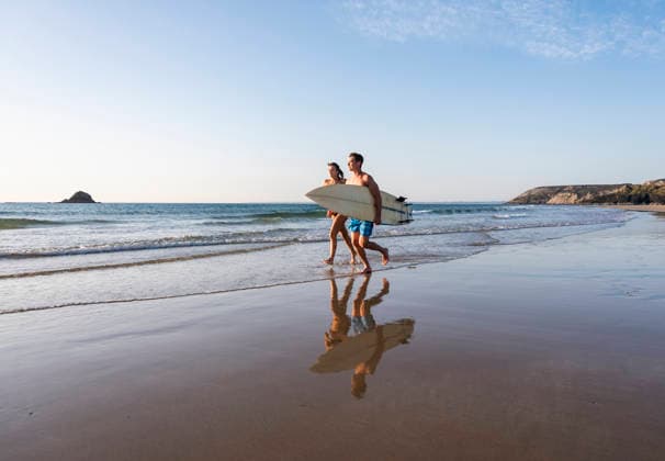 Surfers running with surfboard along the beach on a sunny summer day model released, Symbolfoto, UUF36530