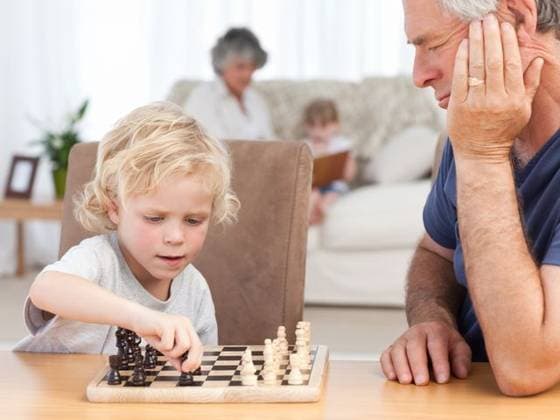 Young boy playing chess with his grandfather Young boy playing chess with his grandfather at home, model released, Cape Town, South Africa, 31.10.2010, 50670.jpg, board, chess, couch, face, family, fun, game, happy, home, house, indoor, innocent, joy, little, modern, play, retired, retirement, room, sitting, small, sofa, table, together, white 60s, Mature Adult, Man, Male, Caucasian, 50s, Woman, Female, Child, Girl, Boy, Caucasian Appearance, 60-64 Years, Senior Men, 55-59 Years, Mature Women, 4-5 Years, Girls, 6-7 Years, Boys