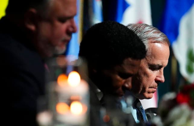 March 24, 2026, Ottawa, Canada: Prime Minister Mark Carney, right, sits beside Michael Pinball Clemons, middle, as they attend the National Prayers Breakfast in Ottawa on Tuesday, March 24, 2026. Ottawa Canada  - ZUMAc35_ 20260324_zaf_c35_004 Copyright: xSeanxKilpatrickx