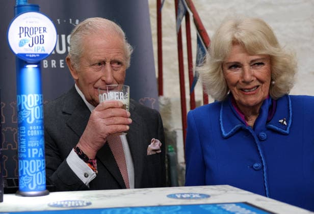 King Charles and Queen Camilla visit Cornwall, UK, 24 March 2026 Britain s Queen Camilla reacts as she stands with Britain s King Charles III, as he tastes a pint of St Austell Brewery s Proper Job IPA 0.5% that he pulled, during a visit to the The Market Hall in St Austell, south-west England on March 24, 2026., Credit:ADRIAN DENNIS Avalon United Kingdom, Cornwall  Copyright: xADRIANxDENNISx xAvalonx 1085919937