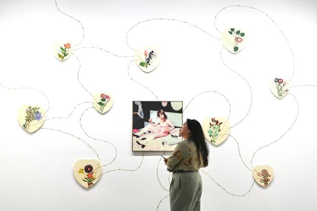 HONG KONG, CHINA - MARCH 25: A woman views an artwork at the preview of Art Basel Hong Kong 2026 at the Hong Kong Convention and Exhibition Center on March 25, 2026 in Hong Kong, China. Art Basel Hong Kong 2026 held its preview on March 25 at the Hong Kong Convention and Exhibition Center, bringing together 240 galleries from 41 countries and regions.  Copyright: xChinaxNewsxServicex 111630800909