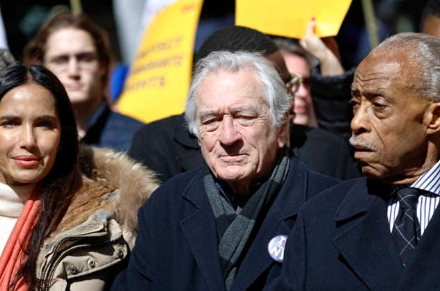 Actor Robert DeNiro, center, with Activist Al Sharpton, right and Television Personality, Padma Lakshmi, left carry a banner as they march down Seventh Avenue during a No Kings demonstration on Saturday, March 28th, 2026 in New York City. People turned out all over the United States to protest the current Trump administration policies.  NYP202603288012 PeterxFoley