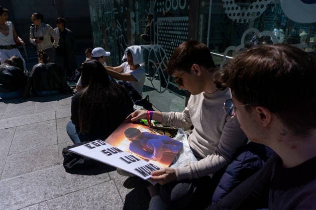 April 1, 2026, Madrid, Spain: A couple of Rosalia fans look through a photo album of Rosalia near the Palacio de los Deportes in Madrid. Rosalia fans gathered around the Palacio de los Deportes ahead of the second of four concerts the Catalan singer Rosalia will give in Madrid. Madrid Spain - ZUMAs197 20260401_aaa_s197_085 Copyright: xDavidxCanalesx
