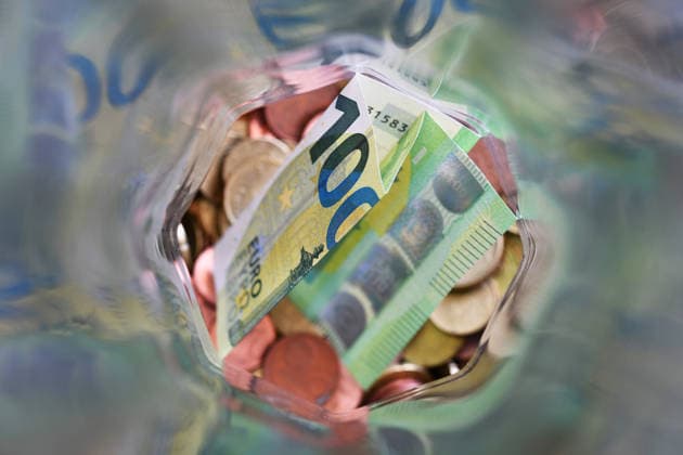 100 euro bill and change in a jar Germany
