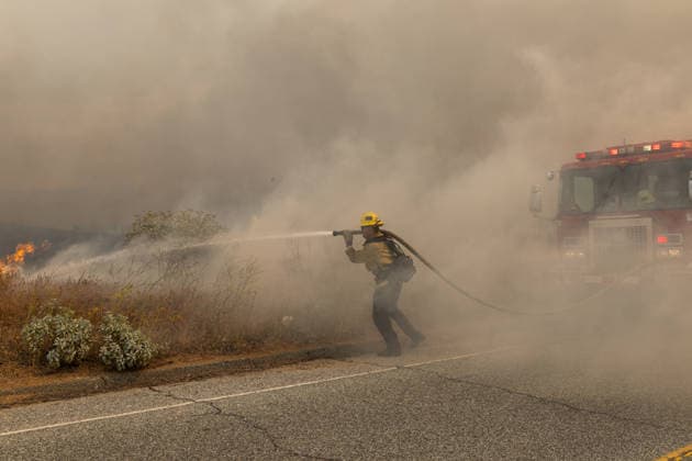 MORENO VALLEY, CA - APRIL 03: Firefighters battle the blaze at the site of the Springs Fire on April 3, 2026 in Moreno Valley, California. A fast-moving brush fire east of Moreno Valley grew to about 3,500 acres on April 3, prompting evacuation orders and road closures.  Copyright: xVCGx 111632626620