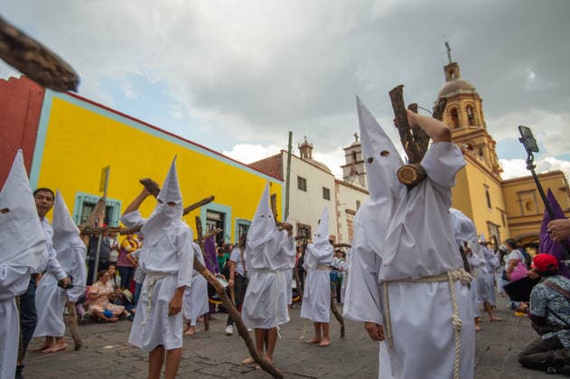 Hooded penitents carry wooden crosses and take a vow of silence as taking part during the procession of silence for Holy Week celebrations in Temple of Santa Cruz, celebrating 60 years of tradition. As Easter approaches, honors one of the solemn religious traditions, the funeral march, know as Silence Procession. on April 3, 2026 in Queretaro, Mexico. Queretaro Mexico  - ZUMAe321 20260403_zia_e321_114 Copyright: xJosexCarrerax