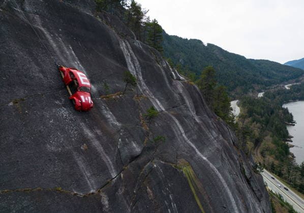 April 6, 2026, Squamish, Bc, CANADA: The shell of a Volkswagen Beetle hangs suspended on a cliff above the Sea-to-Sky Highway, in Squamish, B.C., on Monday, April 6, 2026. The vehicle appeared on the rock face last week with a large E on its roof, indicating that University of British Columbia engineering students were carrying on a long-standing tradition of placing the shell in difficult to reach locations. British Columbia s Environment Ministry is urging people to stay away from the area as they work on a plan to remove it. Squamish CANADA - ZUMAc35_ 20260406_zaf_c35_015 Copyright: xDarrylxDyckx