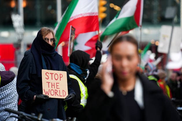 Protest in Toronto against US and Israeli attacks on Lebanon, Iran and Gaza TORONTO, CANADA - APRIL 8 : A protestor holds a sign reading Stop The World as protestors gather outside Consulate General of Israel in Toronto to demonstrate against US and Israeli attacks on Iran, Lebanon and Gaza on April 8, 2026 in Ontario, Canada. Mert Alper Dervis Anadolu Toronto Canada. Editorial use only. Please get in touch for any other usage.  Copyright: x2026xAnadoluxMertxAlperxDervisx