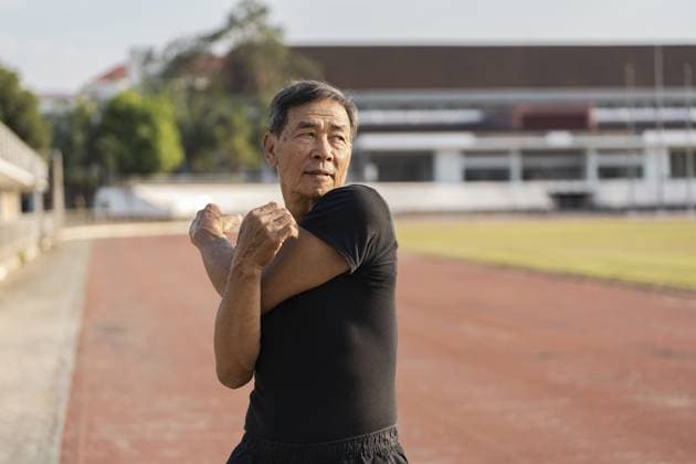 Älterer Mann dehnt sich auf einer Strecke aus und verkörpert aktives Seniorenleben und Wohlbefinden in einer sportlichen Umgebung Elderly man stretching on a track, embodying active senior living and wellness in a sports setting Copyright: imageBROKER WORAWEExMEEPIAN ibxiqx17170101.jpg ,model released, Symbolfoto ,property released