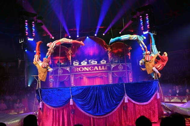 Trampoline artists Venice Carnival and clown Prof Wacko Valdimir Georgiev performing in the ring at the Cologne premiere of Circus Roncalli