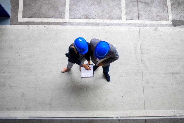 Business partners shaking hands during factory meeting. Business partners shaking hands during factory meeting. Top view, banner. model released