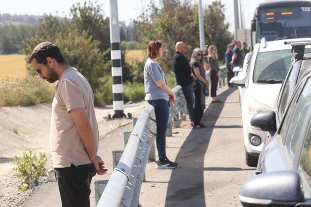 (260414) -- TEL AVIV, April 14, 2026 -- People stand in silence as a siren sounds to commemorate Holocaust victims along a highway near Tel Aviv, Israel, on April 14, 2026. Israel on Monday started commemorating its annual Holocaust Martyrs and Heroes Remembrance Day with an official torch-lighting ceremony in Jerusalem at the country s Holocaust memorial Yad Vashem. Remembrance activities will continue through Tuesday, featuring a wreath-laying ceremony at Yad Vashem, among others. (Photo by Xinhua) ISRAEL-TEL AVIV-HOLOCAUST-COMMEMORATION GilxCohenxMagen 