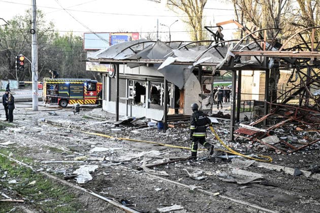 Rescuers work at a public transport stop damaged by a Russian drone strike in Zaporizhzhia, Ukraine, April 15, 2026. The attack killed a 74-year-old woman and damaged the stop, a parking lot, and nearby residential buildings. (Photo by Dmytro Smolienko Ukrinform) Russian strike on Zaporizhzhia kills woman  Copyright: xDmytroxSmolienkox