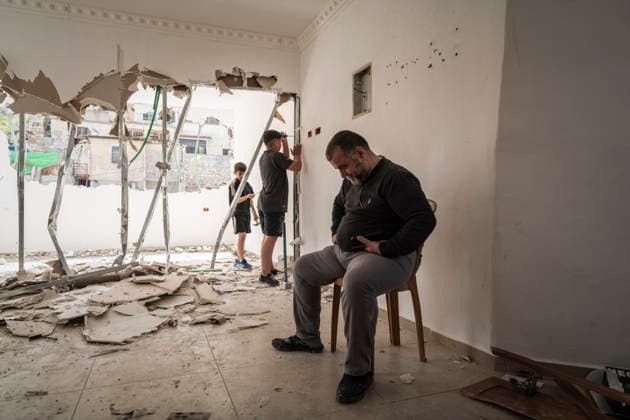 April 16, 2026, Jerusalem, Basel, Switzerland: Omar Abu Rajab, 60, sits on a chair while his nephews Brahim 11 and Ouday 13, work on the demolition of their house following the order of the Jerusalem Municipality, in the annexed East Jerusalem district of Silwan. Jerusalem Switzerland  - ZUMAp199 20260416_zip_p199_007 Copyright: xMatteoxPlacuccix