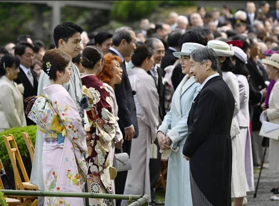 Japanese imperial garden party Milan Cortina Olympic pairs figure skating gold medalists Riku Miura (front, far L) and Ryuichi Kihara (front, 2nd from L) chat with Japanese Emperor Naruhito (front, far R) and Empress Masako (front, 2nd from R) during a spring imperial garden party at the Akasaka Imperial Gardens in Tokyo on April 17, 2026. The pair announced their retirement from competition the same day.  A14AA0005466162P