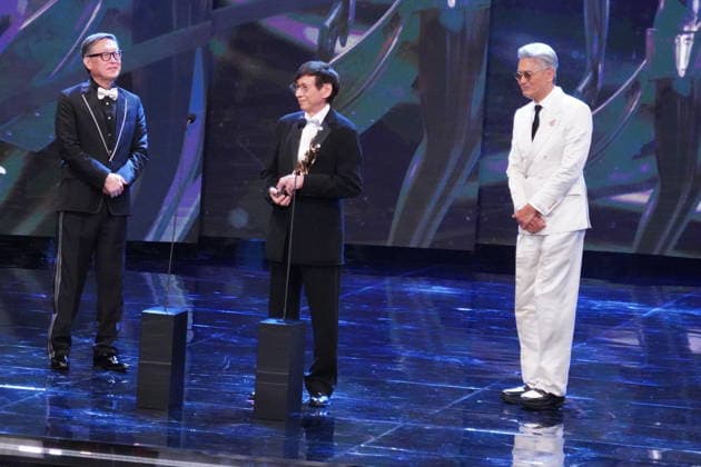 HONG KONG, CHINA - APRIL 19: Director Andrew Lau Wai-Keung (L), actor Chow Yun-fat (R) present the trophy to film producer and executive John Chu Ka-yan on the stage at the 44th Hong Kong Film Awards on April 19, 2026 in Hong Kong, China.  Copyright: xVCGx 111635887817