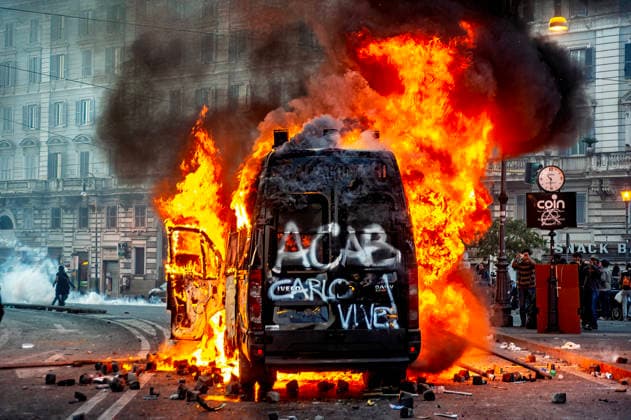 Protest against the crisis and austerity measures ROME, ITALY - OCTOBER 15: A Carabinieri armored vehicle set on fire by protesters in Piazza San Giovanni. The words Carlo Vive? the painted on the vehicle, in memory of Carlo Giuliani, who was killed in Genoa during the G8 summit by a Carabinieri officer during a demonstration against the austerity policies imposed by the European Union and the ECB on October 15, 2011 in Rome, Italy. The day of mobilization was inspired by the Spanish Indignados movement, and protests are taking place around the world. Rome Italy Copyright: xStefanoxMontesix
