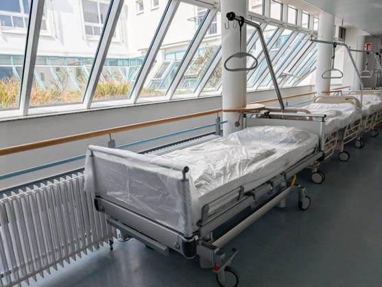 Bavaria, Germany April 16, 2026: Empty hospital beds in a clinic symbolize the nursing crisis and the decline of hospitals. The scene highlights challenges in the healthcare system, such as staff shortages, the need for reform, and ensuring medical care
