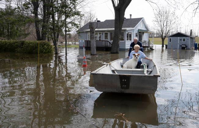 April 22, 2026, Rigaud, Pq, CANADA: Homeowners Chris and Sue evacuate from their home with their dog Buddy as flood waters rise in Rigaud, Que., on Wednesday, April 22, 2026. Rigaud CANADA  - ZUMAc35_ 20260422_zaf_c35_026 Copyright: xChristinnexMuschix
