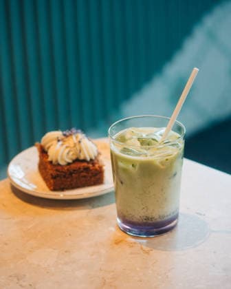 matcha latte and cake on a table in a cafe Stockholm, Stockholm County, Sweden CR_RABE260421D7-1991013-01