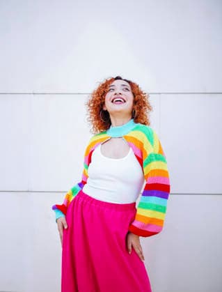 Red haired woman in colorful rainbow fashion smiling joyfully model released, Symbolfoto, SVCF00631