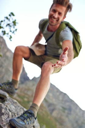 Lending a hand. a handsome young man offering you a hand up the mountain (License=RF) ,model released, Symbolfoto  Copyright: xZoonar.com KasperxRavlox 19085499 ,model released, Symbolfoto ,property released