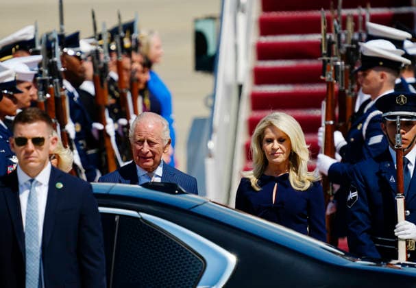 Britain s King Charles III and Queen Camilla (partially hidden) are joined by U.S. Chief of Protocol Monica Crowley (R) during a flight line arrival ceremony at Joint Base Andrews in Suitland, Maryland on Monday, April 27, 2026. The king is on a four-day state visit to the U.S. and will stop in New York and Washington, where he will meet with President Trump and deliver an address to Congress.  WAP20260427804 BONNIExCASH
