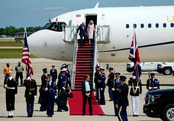 Britain s King Charles III and Queen Camilla walk down a red carpet during a flight line arrival ceremony at Joint Base Andrews in Suitland, Maryland on Monday, April 27, 2026. .The king is on a four-day state visit to the U.S. and will stop in New York and Washington, where he will meet with President Trump and deliver an address to Congress.  WAP20260427806 BONNIExCASH