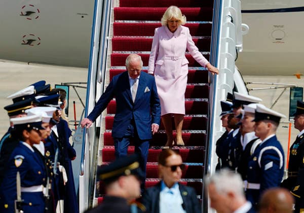 Britain s King Charles III and Queen Camilla walk down a red carpet during a flight line arrival ceremony at Joint Base Andrews in Suitland, Maryland on Monday, April 27, 2026. .The king is on a four-day state visit to the U.S. and will stop in New York and Washington, where he will meet with President Trump and deliver an address to Congress.  WAP20260427809 BONNIExCASH
