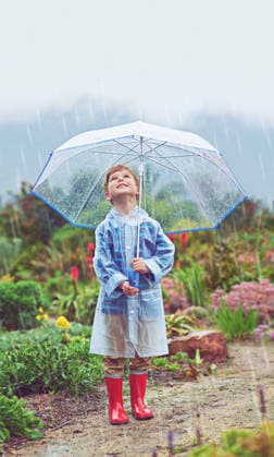 My garden loves the rain. Full length shot of a young boy standing outside in the rain (License=RF) ,model released, Symbolfoto  Copyright: xZoonar.com YurixArcursx 19390364 ,model released, Symbolfoto ,property released