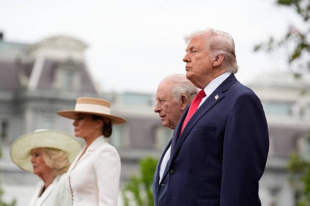 Britain s King Charles III and Queen Camilla stand on the podium with President Donald Trump and First Lady Melania Trump at an official welcoming ceremony at the White House in Washington DC on Tuesday, April 28, 2026. The king is on a four-day state visit to the U.S. and will stop in New York and Washington, where he will meet with U.S. officials and deliver an address to Congress.  WAX20260428821 YURIxGRIPAS