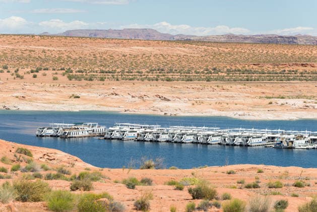 Lake Powell, AZ - 05 02 2017: Houseboats on Lake Amidst Arid Desert Oljato-Monument Valley, Arizona, United States R_YECJHG260428AE-2009868-01 EDITORIAL USE ONLY