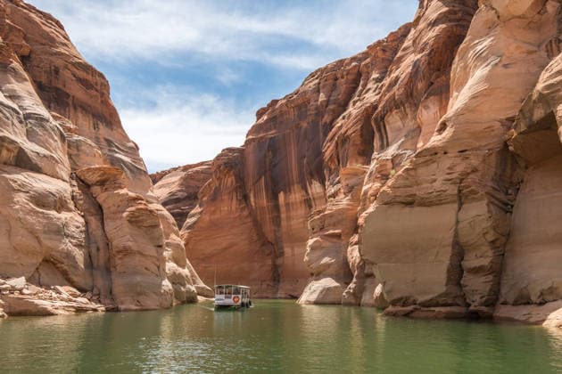 Lake Powell, AZ, USA - 05 02 2017: Houseboat Amidst Majestic Canyons Oljato-Monument Valley, Arizona, United States R_YECJHG260428AE-2009874-01 EDITORIAL USE ONLY
