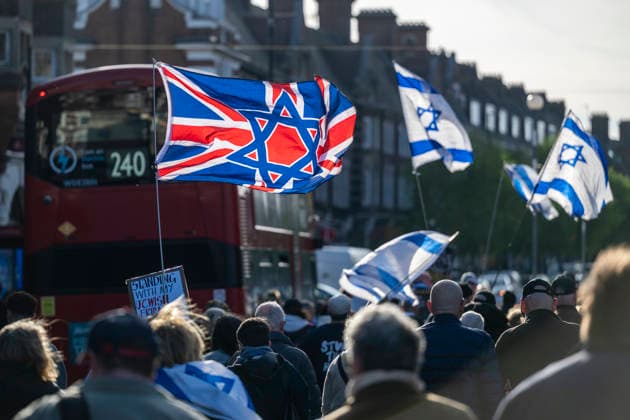 April 29, 2026, London, London, UK: LONDON, UK. Members of the Stop the Hate movement with Israel flags stage a march in Golders Green High Road after police reported that two Jewish men were stabbed earlier today in what they have now declared a terrorist incident. The victims, aged 76 and 34, are in a stable condition and the suspect, aged 45, who also attempted to stab officers was Tasered and arrested on suspicion of attempted murder. London UK  - ZUMAl94_ 20260429_zaf_l94_060 Copyright: xStephenxChungx