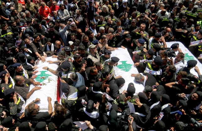 April 30, 2026, Tyre,, Lebanon: Mourners gather around the coffins of three Lebanese Civil Defense members, who were killed in an Israeli air strike in the southern Lebanese village of Majdal Zoun, during their funeral procession in the port city of Tyre. The Israeli military has intensified its campaign in southern Lebanon, issuing new evacuation orders for residents in numerous villages, warning them not to return to the area. Tyre Lebanon  - ZUMAn313 20260430_zip_n313_001 Copyright: xMarwanxNaamanix