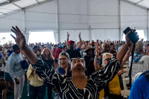 People sing as The New Orleans Gospel and Soul Children perform in the Gospel Tent at the New Orleans Jazz and Heritage Festival at the Fairgrounds Race Courts and Slots in New Orleans, Louisiana on Sunday, May 3, 2026. Organizers expected about 400,000 to attend, but the finally tally, which won t be available for a few days, may be impacted by rain that interrupted festival operations Thursday and Friday.  NOL20260503310 BONNIExCASH