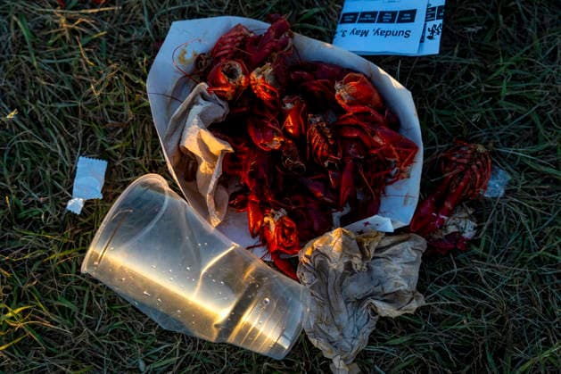 Crawfish, empty lemonade bottles and a schedule from closing day are left after the New Orleans Jazz and Heritage Festival concludes at the Fairgrounds Race Courts and Slots in New Orleans, Louisiana on Sunday, May 3, 2026. Organizers expected about 400,000 to attend, but the finally tally, which won t be available for a few days, may be impacted by rain that interrupted festival operations Thursday and Friday.  NOL20260503319 BONNIExCASH