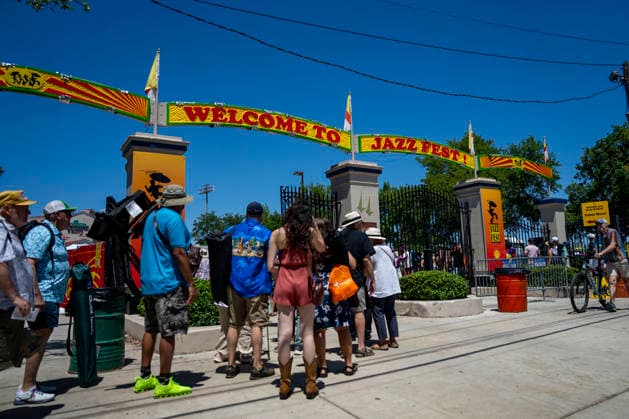 People wait to enter the New Orleans Jazz and Heritage Festival at the Fairgrounds Race Courts and Slots in New Orleans, Louisiana on Sunday, May 3, 2026. Organizers expected about 400,000 to attend, but the finally tally, which won t be available for a few days, may be impacted by rain that interrupted festival operations Thursday and Friday.  NOL20260503300 BONNIExCASH