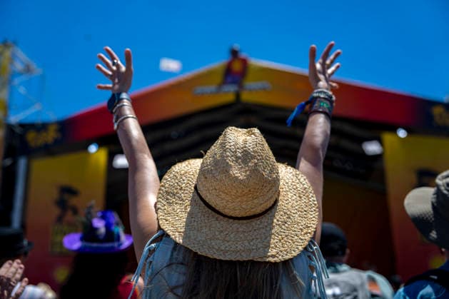 A woman dances as Big Sam s Funky Nation plays at the Festival Stage at the New Orleans Jazz and Heritage Festival at the Fairgrounds Race Courts and Slots in New Orleans, Louisiana on Sunday, May 3, 2026. Organizers expected about 400,000 to attend, but the finally tally, which won t be available for a few days, may be impacted by rain that interrupted festival operations Thursday and Friday.  NOL20260503304 BONNIExCASH