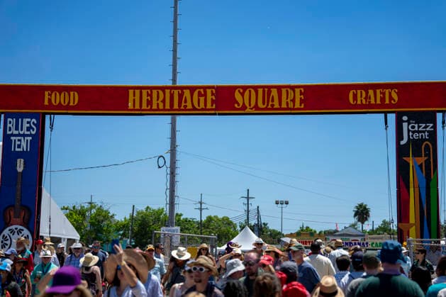 People walk towards Heritage Square, which houses the Blues and Jazz Tent, at the New Orleans Jazz and Heritage Festival at the Fairgrounds Race Courts and Slots in New Orleans, Louisiana on Sunday, May 3, 2026. Organizers expected about 400,000 to attend, but the finally tally, which won t be available for a few days, may be impacted by rain that interrupted festival operations Thursday and Friday.  NOL20260503305 BONNIExCASH