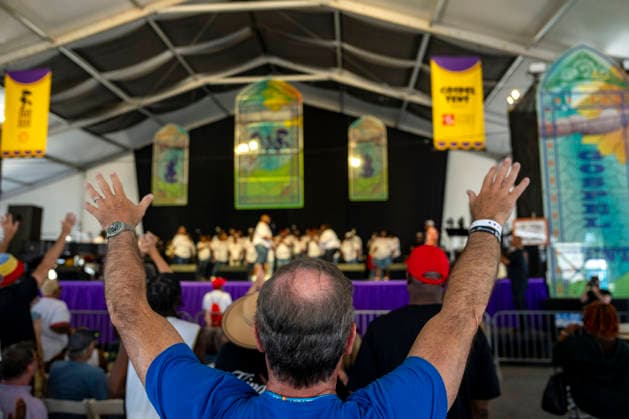 People dance as The New Orleans Gospel and Soul Children perform in the Gospel Tent at the New Orleans Jazz and Heritage Festival at the Fairgrounds Race Courts and Slots in New Orleans, Louisiana on Sunday, May 3, 2026. Organizers expected about 400,000 to attend, but the finally tally, which won t be available for a few days, may be impacted by rain that interrupted festival operations Thursday and Friday.  NOL20260503307 BONNIExCASH