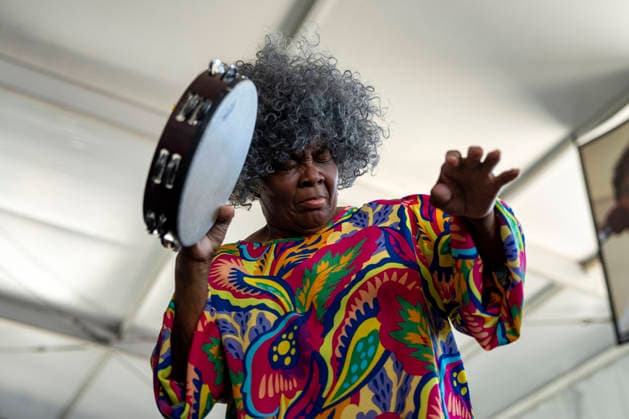 A woman plays the tambourine as The New Orleans Gospel and Soul Children perform in the Gospel Tent at the New Orleans Jazz and Heritage Festival at the Fairgrounds Race Courts and Slots in New Orleans, Louisiana on Sunday, May 3, 2026. Organizers expected about 400,000 to attend, but the finally tally, which won t be available for a few days, may be impacted by rain that interrupted festival operations Thursday and Friday.  NOL20260503308 BONNIExCASH