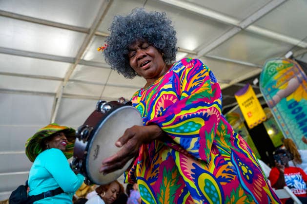 A woman plays the tambourine as The New Orleans Gospel and Soul Children perform in the Gospel Tent at the New Orleans Jazz and Heritage Festival at the Fairgrounds Race Courts and Slots in New Orleans, Louisiana on Sunday, May 3, 2026. Organizers expected about 400,000 to attend, but the finally tally, which won t be available for a few days, may be impacted by rain that interrupted festival operations Thursday and Friday.  NOL20260503309 BONNIExCASH
