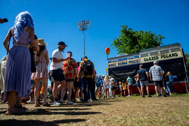 People wait in line for Mango Freeze s outside the Fais-Do-Do Stage at the New Orleans Jazz and Heritage Festival at the Fairgrounds Race Courts and Slots in New Orleans, Louisiana on Sunday, May 3, 2026. Organizers expected about 400,000 to attend, but the finally tally, which won t be available for a few days, may be impacted by rain that interrupted festival operations Thursday and Friday.  NOL20260503316 BONNIExCASH