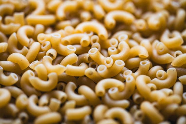 Close up of lots of dry uncooked macaroni pasta filling frame. Kingston, Ontario, Canada R_DOHO260502B-2010683-01