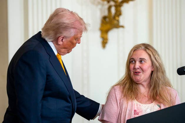 President Donald Trump speaks with Melody Wolfe, mother of SSgt. Andrew Wolfe, the National Guardsman who was shot outside the White House last year, during an event honoring military mothers and spouses in the East Room of the White House in Washington, DC on Wednesday, May 6, 2026.  WAP20260506324 BONNIExCASH